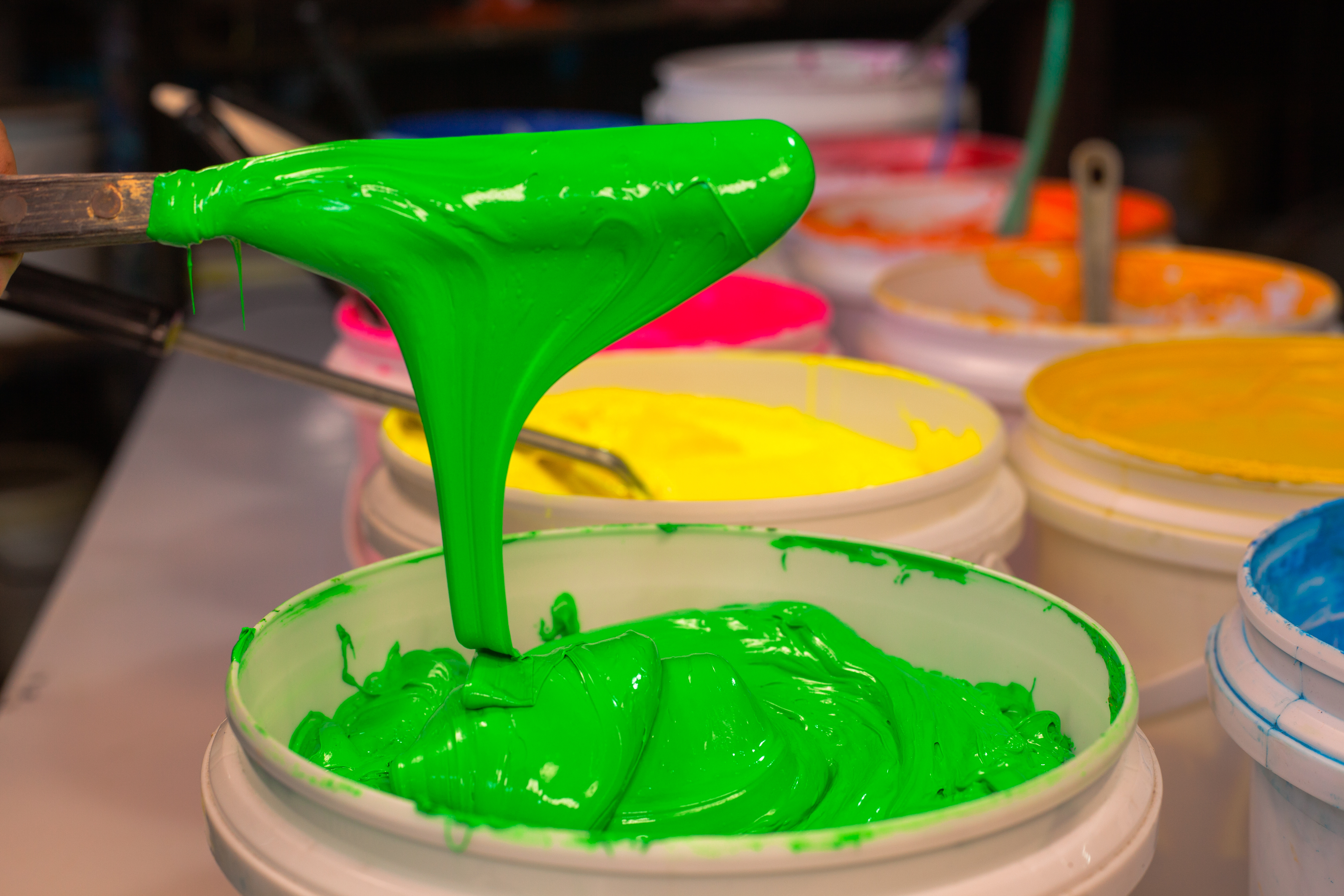 Green ink being poured for a print run